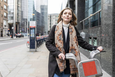 Woman in the city using rental bike, London, UK - WPEF02766