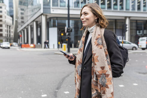 Woman in the city crossing the street, London, UK - WPEF02771