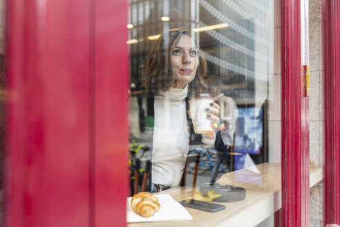 Businesswoman having a coffee break at a cafe in the city - WPEF02778