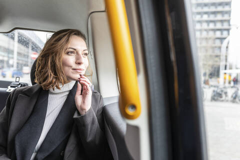 Woman in the rear of a taxi looking out of the window, London, UK stock photo