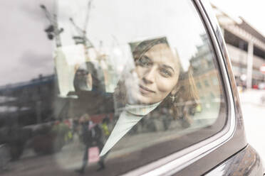 Woman in the rear of a taxi looking out of the window, London, UK - WPEF02795