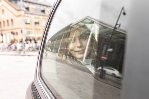 Woman in the rear of a taxi looking out of the window, London, UK - WPEF02796