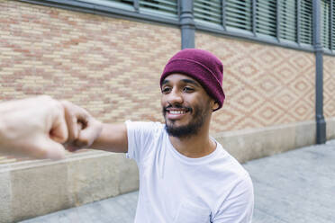 Portrait of smiling man bumping fist - XLGF00016