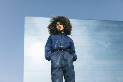 Portrait of stylish young woman wearing tracksuit outdoors - AGGF00023