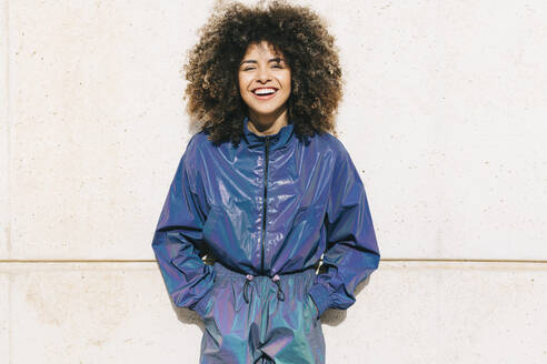 Portrait of happy stylish young woman wearing tracksuit outdoors - AGGF00028
