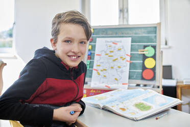 Portrait of smiling boy, learning at home - DIKF00437