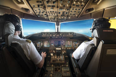 Rear View Of Pilots Sitting In Cockpit - EYF04164