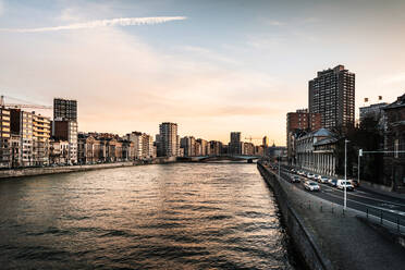 River Amidst Buildings In City Against Sky During Sunset - EYF04187