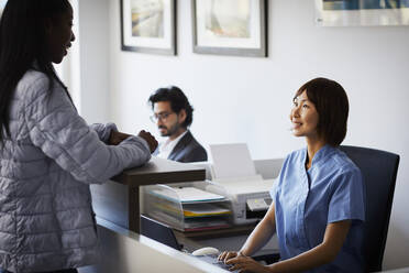 Patient at reception desk of a dental practice - PWF00001