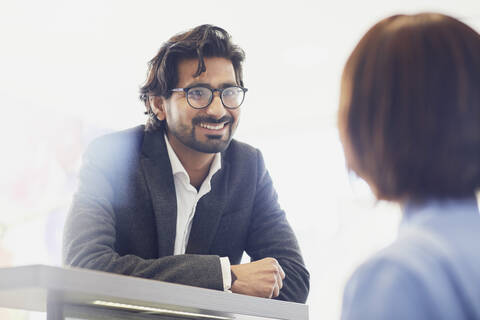 Smiling patient at reception desk of a dental practice stock photo