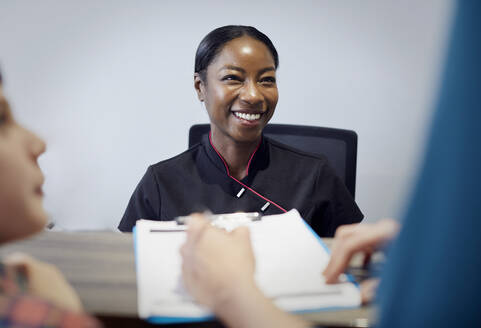 Portrait of smiling receptionist in a dental practice - PWF00036