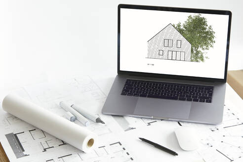 Architecture model of home ownership with tree on screen of laptop, construction plan - RBF07549