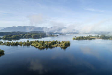 Germany, Bavaria, Murnau am Staffelsee, Drone view of fog floating over Gradeneiland, Worth and Buchau islands on Staffelsee lake - RUEF02808