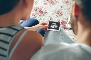 Couple Sitting On Bed At Home - EYF04336