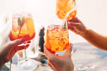 Cropped Hands Of Women Holding Alcoholic Drinks - EYF04342