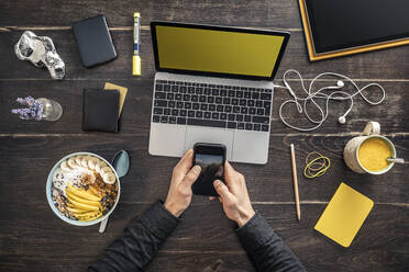 Overhead view of man working at desk in home office - MSUF00265