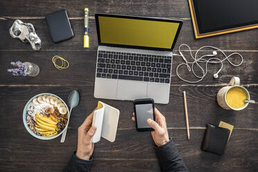 Overhead view of man working at desk in home office - MSUF00266