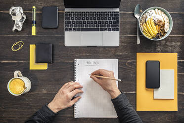 Overhead view of man working at desk in home office - MSUF00268