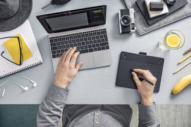 Overhead view of man working at desk in home office - MSUF00273