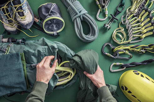 Overhead view of man packing climbing utensils - MSUF00278