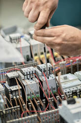 Close-up of electrician working on circuitry - ZEDF03202