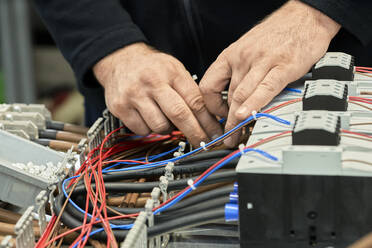 Nahaufnahme eines Elektrikers bei der Arbeit an einem Schaltkreis - ZEDF03203