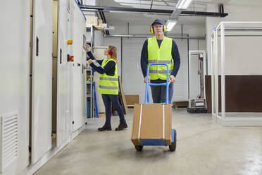 Man and woman in reflective vests at work - ZEDF03238