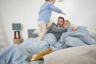 Family relaxing and jumping on bed - FSF01017