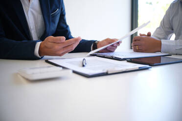 Cropped Image of Insurance Agent Discussing With Client At Desk - EYF04614
