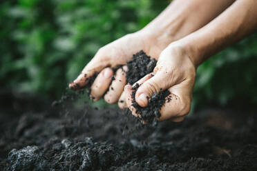 Close-Up Of Man Holding Soil - EYF04673