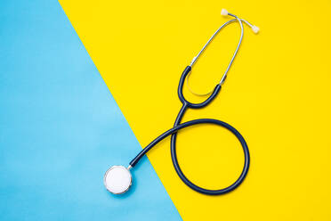 High Angle View Of Stethoscope On Colored Background - EYF04821
