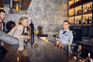 Barwoman preparing drinks in a bar - ZEDF03258