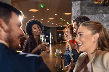 Happy friends socializing in a bar - ZEDF03302