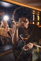 Cheerful woman having a cocktail in a bar - ZEDF03309