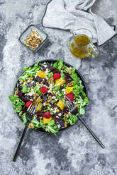 Plate of mixed salad with feta cheese, beetroot, walnuts, corn salad, raspberries, oranges and pine nuts - SARF04532