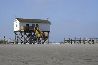 Germany, Schleswig-Holstein, Sankt Peter-Ording, Beach sand in front of coastal stilt house - WIF04234