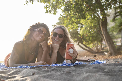 Zwei glückliche Frauen machen ein Selfie am Strand, Costa Rica - AMUF00074