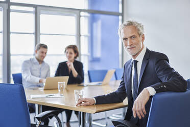 Portrait of confident manager during a meeting in office - RORF02113