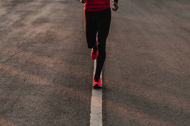 Low Section Of Athlete Running On Road - EYF04923