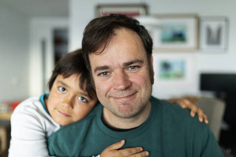 Portrait of father at home with his son stock photo