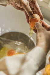 Hands of woman cracking egg into bowl - ACPF00682