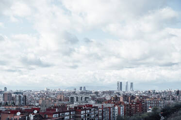 Spain, Madrid, Large white clouds over city downtown - JCMF00579