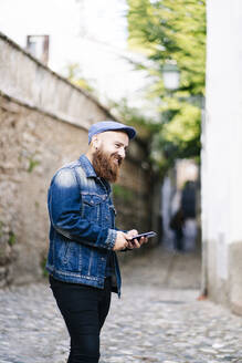 Tourist mit Smartphone in der Stadt, Albaicin, Granada, Spanien - DGOF00825