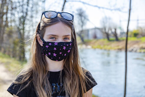 Girl with homemade protective mask at riverside - SARF04535