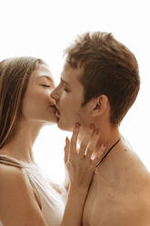 Portrait of intimate young couple kissing - GMLF00054