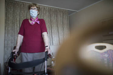 Senior woman with wheeled walker in her flat, retirement home - JATF01176