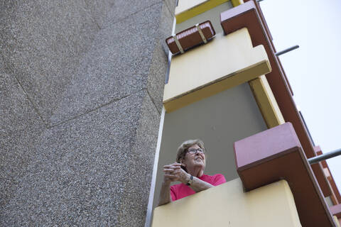 Senior woman on balcony, retirement home stock photo