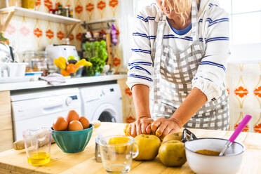 Woman preparing a cake in her kitchen - SIPF02150