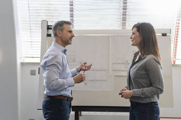 Businessman and businesswoman having a meeting in office - DIGF09669