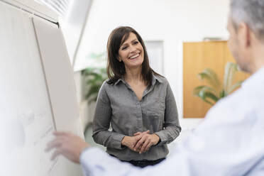 Businessman and businesswoman having a meeting in office - DIGF09672